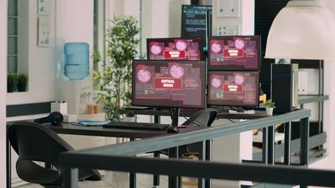 Empty agency office with multiple monitors showing system crash warning 写真素材