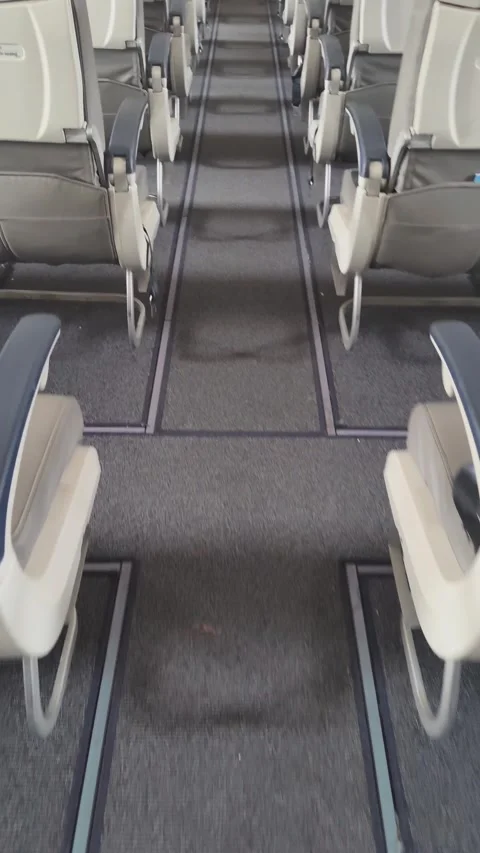 Empty airplane cabin interior with rows of seats along the aisle. Stock Footage 313241107