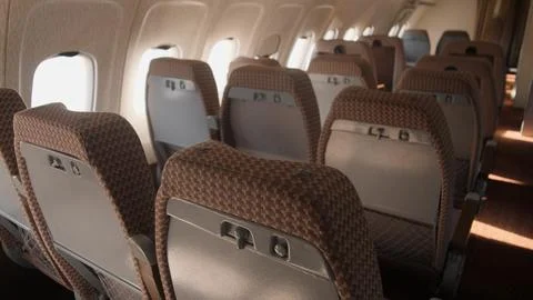 Empty Airplane Interior With Rows of Seats and Soft Lighting Providing a Ca.. Stock Photos