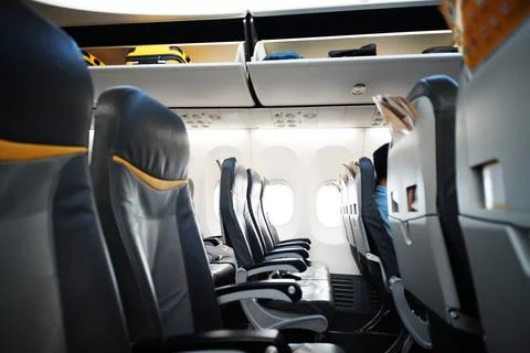 Empty airplane seats in the cabin Stock Photos