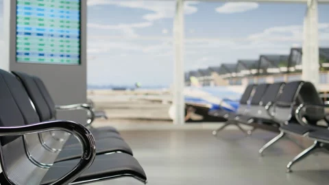 Empty airport lounge with view of runway and board displaying flight details Stock Footage 343736292