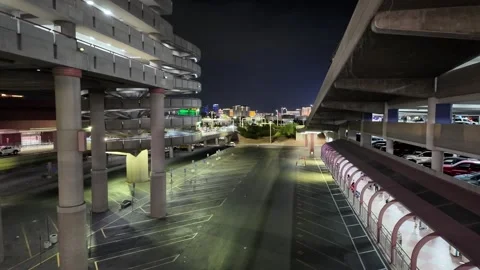 Empty Airport Parking Lot at Night With City Lights in the Distance Stock Footage 316800398