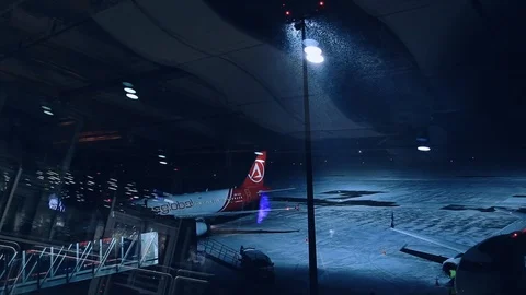 Empty airport runway with one plane only illuminated with a pole. Snowy weather Video stock 105272829