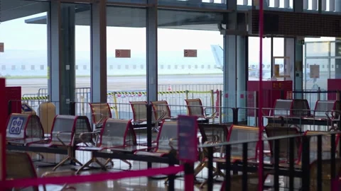 Empty airport seating area with a view of parked airplanes, creating a calm.. Stock Footage 293122008
