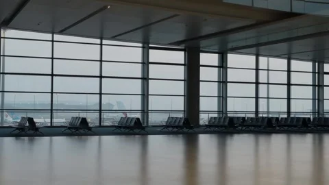 Empty airport terminal lounge with panoramic windows and aircraft outside Stock Footage 339010257