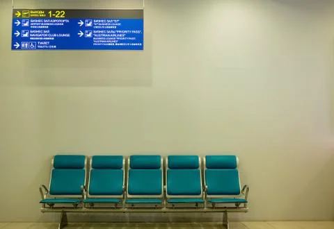 Empty airport terminal waiting area with chairs Stock Photos