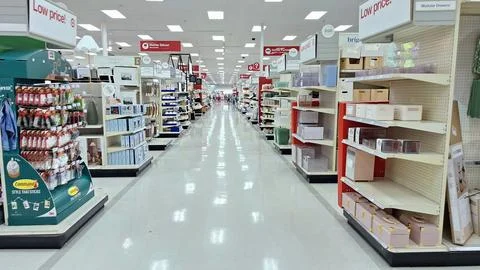 Empty aisle inside a bright retail store. Stock Photos