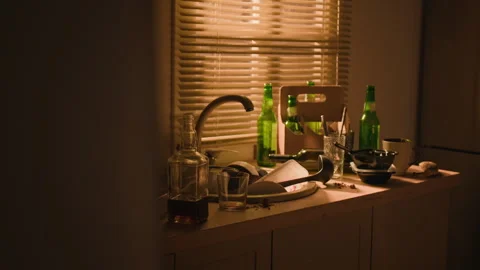 Empty Alcohol Bottles Littering Messy Kitchen Counter in Morning Light Stock Footage 344876002