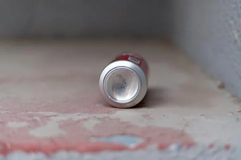 Empty aluminum can lying on ground street litter close up Stock Photos