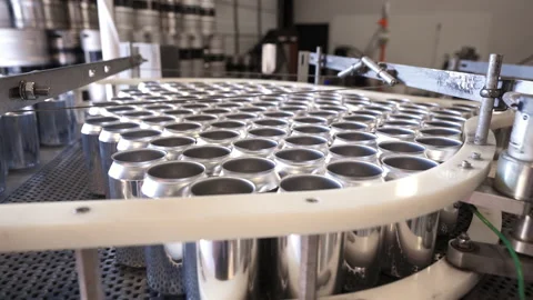 Empty aluminum cans bottleneck at conveyor belt during bottling production Stock Footage 161376442