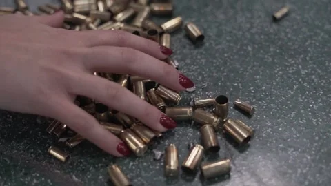 Empty Ammunition on the Ground and a Hand in 4K Slow Motion Vídeos de archivo 297082813