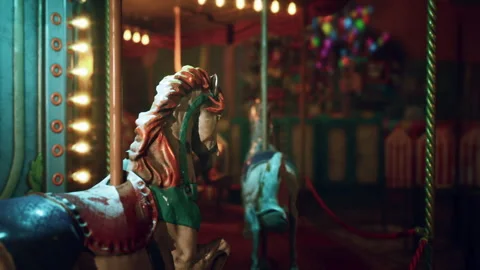 Empty amusement park carousel at night with colorful lights and shadows 動画素材 306721145