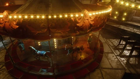 Empty amusement park at night featuring a lit carousel and vacant rides Видео 312380771