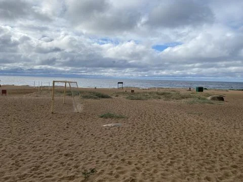 Empty and abandoned sandy beach in the daytime. Stock Photos