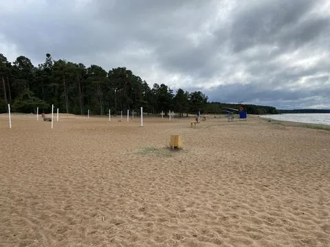 Empty and abandoned sandy beach in the daytime. Stock Photos