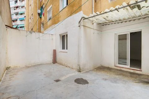 Empty and old patio of typical apartment in Barcelona. Worn out courtyard on Stock Photos