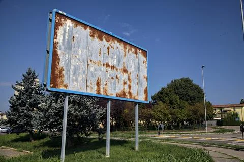 Empty and rusty billboard by the edge of a road in the italian countryside Stock Photos
