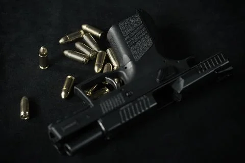 Empty and unloaded semi automatic 9 mm compact handgun on table Stock Photos
