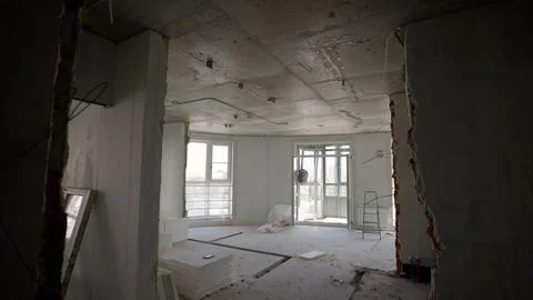 Empty apartment interior under construction, featuring bare walls, concrete.. Foto stock