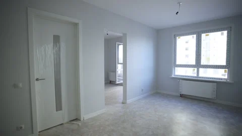 Empty apartment with white walls and open balcony door Stock Footage 330992967