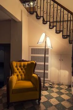 Empty armcahir with floor lamp under gloomy light Foto stock