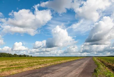 Empty asphalt country road perspective with dramatic cloudy sky Stock Photos
