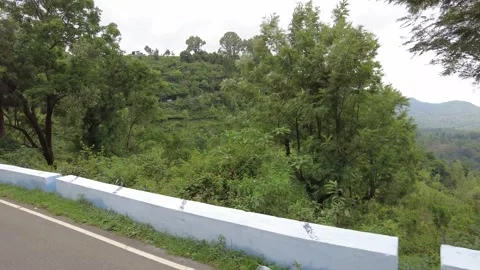 Empty asphalt ghat road with a plain whitewashed parapet Stock Footage 346334939