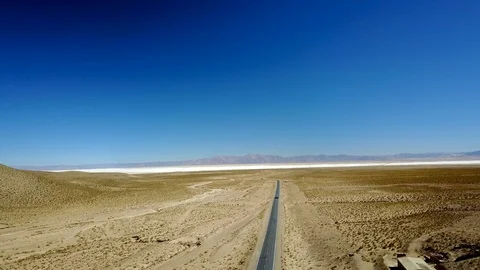 Empty asphalt highway on arid landscape AERIAL DESCENDING SHOT Stock Footage 88515125