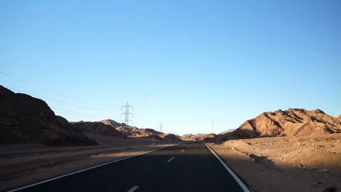 Empty asphalt highway in the desert with road surface marking lines at sunset Stock Footage 251740109