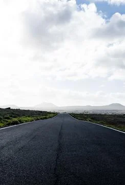 Empty asphalt highway with fields on the background Stock Photos