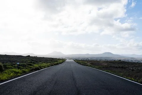 Empty asphalt highway with fields on the background Stock Photos