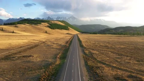 Empty Asphalt Highway Passing Through Desert To Snowy Mountains Aerial View Stock Footage 161489027
