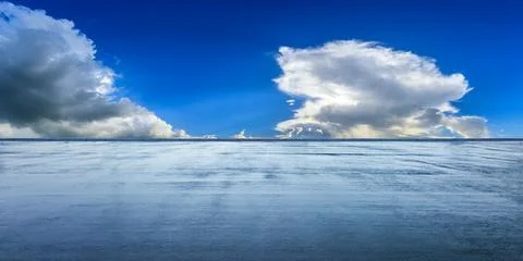 Empty asphalt road and blue sky with white clouds. Stock Photos