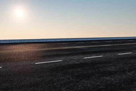 The empty Asphalt road and daylight sky and sunshine. Stock Illustration