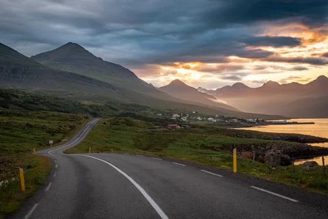 Empty asphalt road and dramatic sunset in southern fjords, Iceland Stock Photos