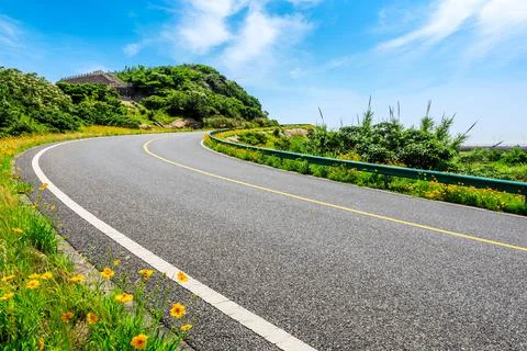 Empty asphalt road and green mountain nature landscape. Stock Photos