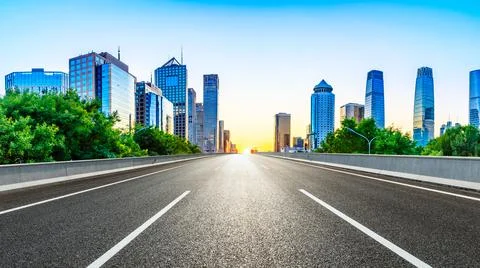 Empty asphalt road and modern cityscape in Beijing at sunset,China. Stock Photos