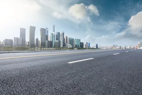 Empty asphalt road and modern commercial buildings in Shanghai. Stock Photos
