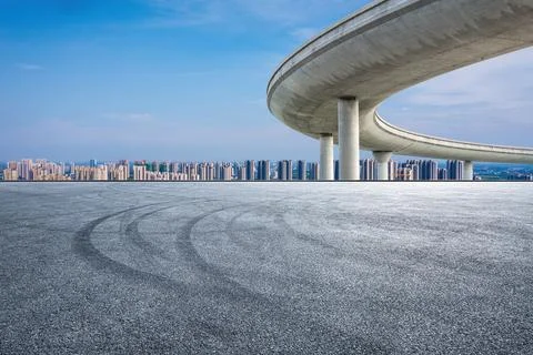 Empty asphalt road and modern city skyline with building scenery. Stock Photos