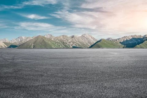 Empty asphalt road and mountain under blue sky. Stock Photos