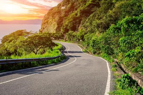 Empty asphalt road and mountain with sea natural landscape Stock Photos