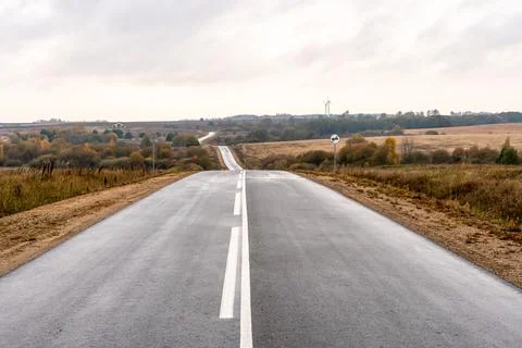 Empty asphalt road close-up against the sky. Empty background, space for text Stock Photos