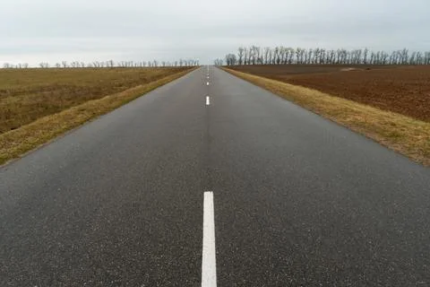 Empty asphalt road close-up against the sky. Empty background, space for text Stock Photos