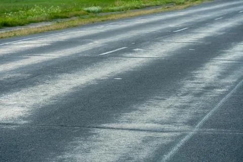 Empty asphalt road close-up against the sky. Empty background, space for text Stock Photos