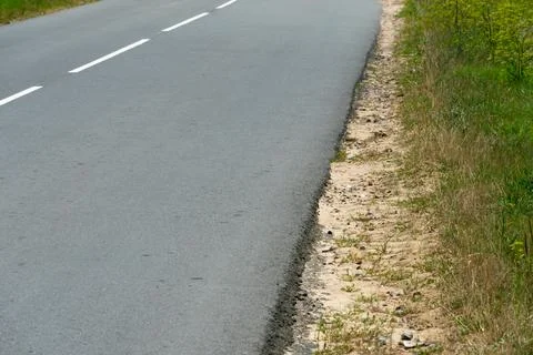 Empty asphalt road close-up against the sky. Empty background, space for text Stock Photos