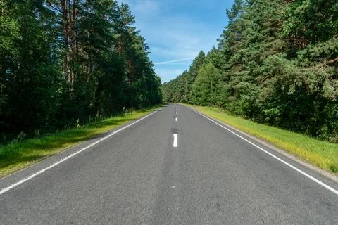 Empty asphalt road close-up against the background of the forest. Empty backg Stock Photos