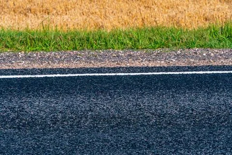 Empty asphalt road close-up against the sky. Empty background, space for text Stock Photos