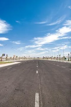 Empty asphalt road with cloudy sky and sunlight Stock Photos