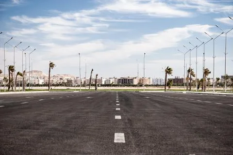 Empty asphalt road with cloudy sky and sunlight Stock Photos