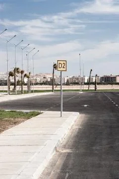 Empty asphalt road with cloudy sky and sunlight Stock Photos